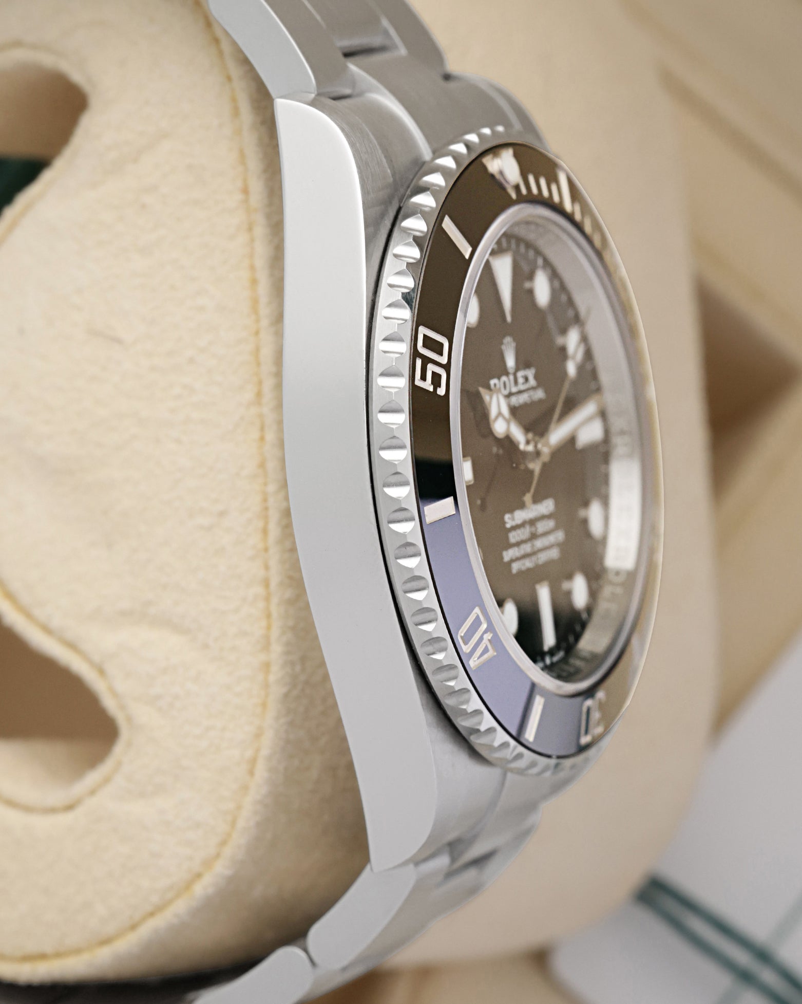 Left side perspective showcasing the high-polish finish on the steel case side and the distinct knurled edge profile of the ceramic bezel