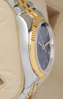 Left side perspective showcasing the polished steel case side profile and the distinct texture of the 18k gold fluted dress bezel