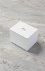 Official minimalist white IWC Schaffhausen outer watch packaging box resting on a marble surface