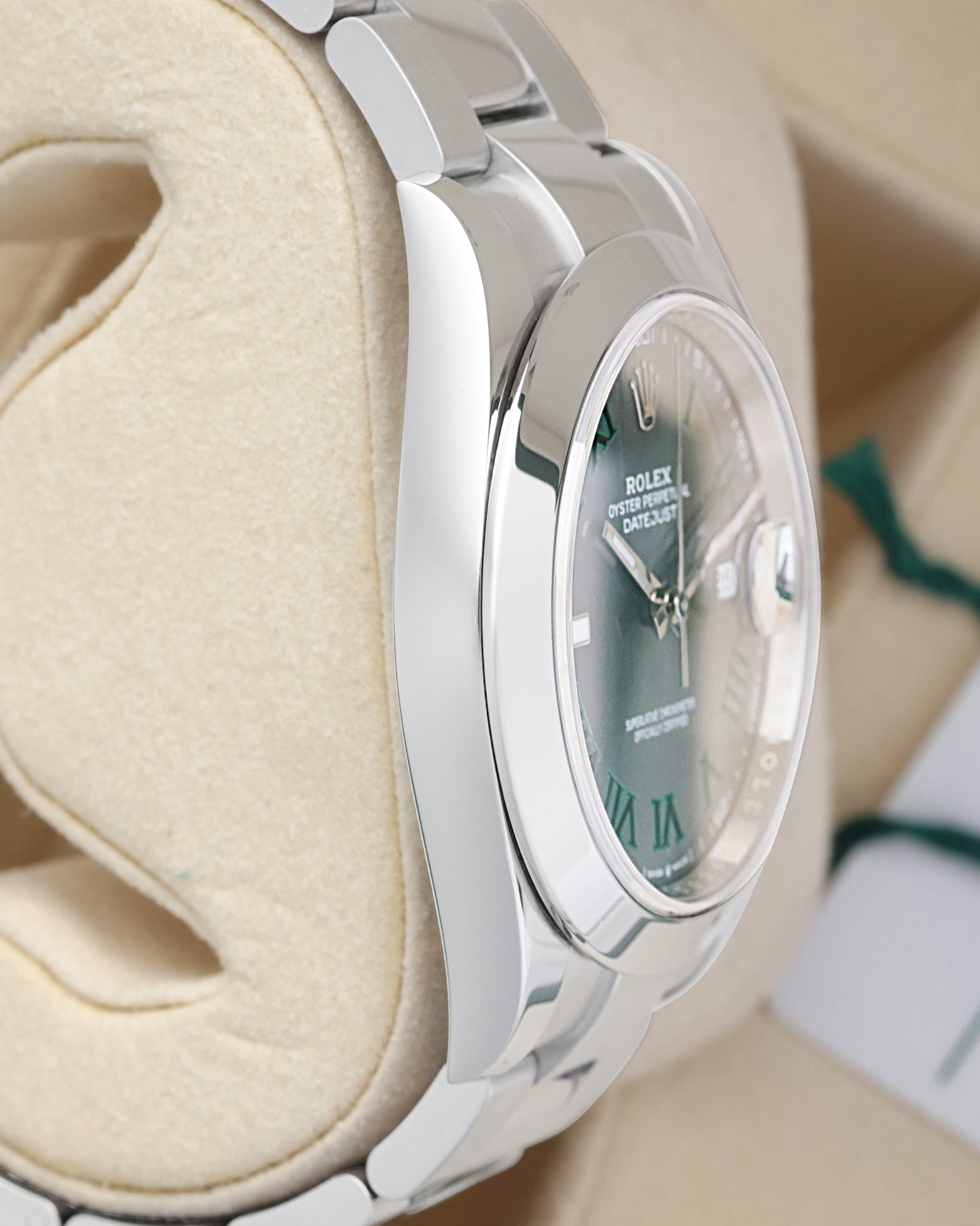 Side profile view of the polished 904L Oystersteel case on the non-crown side of a 41mm Rolex Datejust 126300 watch