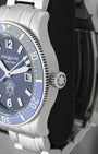 Close-up right profile view of the 1858 Iced Sea watch head focusing on the knurled blue ceramic timing ring and the fluted crown engraved with the iconic white Montblanc star emblem
