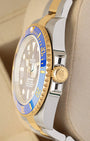 Right side profile view highlighting the 18k yellow gold winding crown and blue Cerachrom ceramic bezel on a Rolex Submariner Bluesy