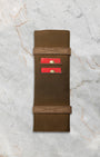 The official military-inspired brown waxed canvas and leather travel watch roll pouch included with the full set No Time To Die package