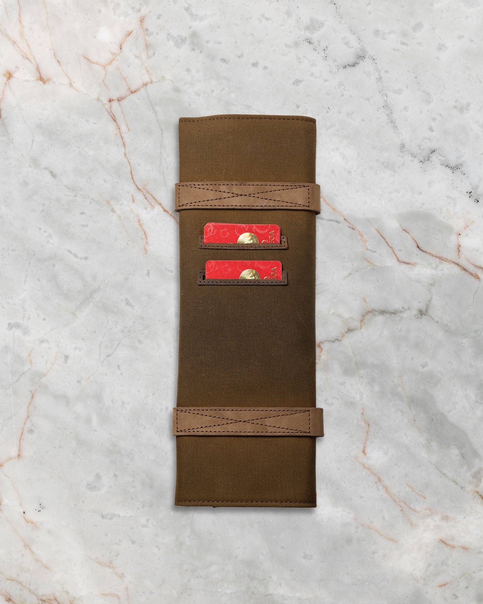 The official military-inspired brown waxed canvas and leather travel watch roll pouch included with the full set No Time To Die package