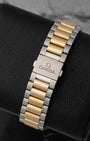 A rear view of the integrated bracelet with 18k gold center links and steel external links, focusing on the seamless closure of the hidden butterfly deployment buckle