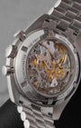 The reverse profile view through a sapphire crystal exhibition caseback revealing the manual-winding Omega Calibre 3861 movement with luxury rhodium-plated finishes