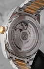 The sapphire exhibition caseback revealing the automatic calibre 8800 movement, showing the arabesque Geneva waves and the distinctive wave-edged luxury steel case rim