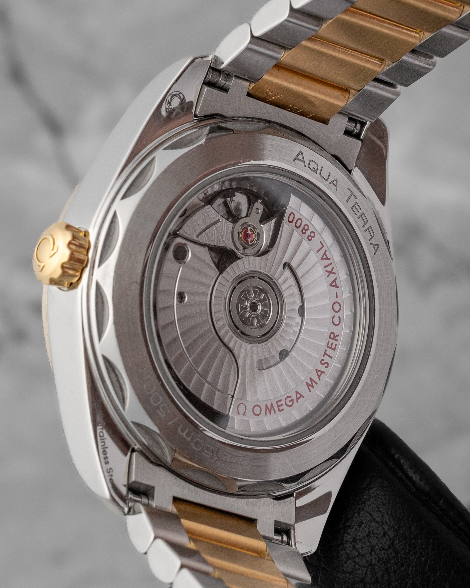 The sapphire exhibition caseback revealing the automatic calibre 8800 movement, showing the arabesque Geneva waves and the distinctive wave-edged luxury steel case rim