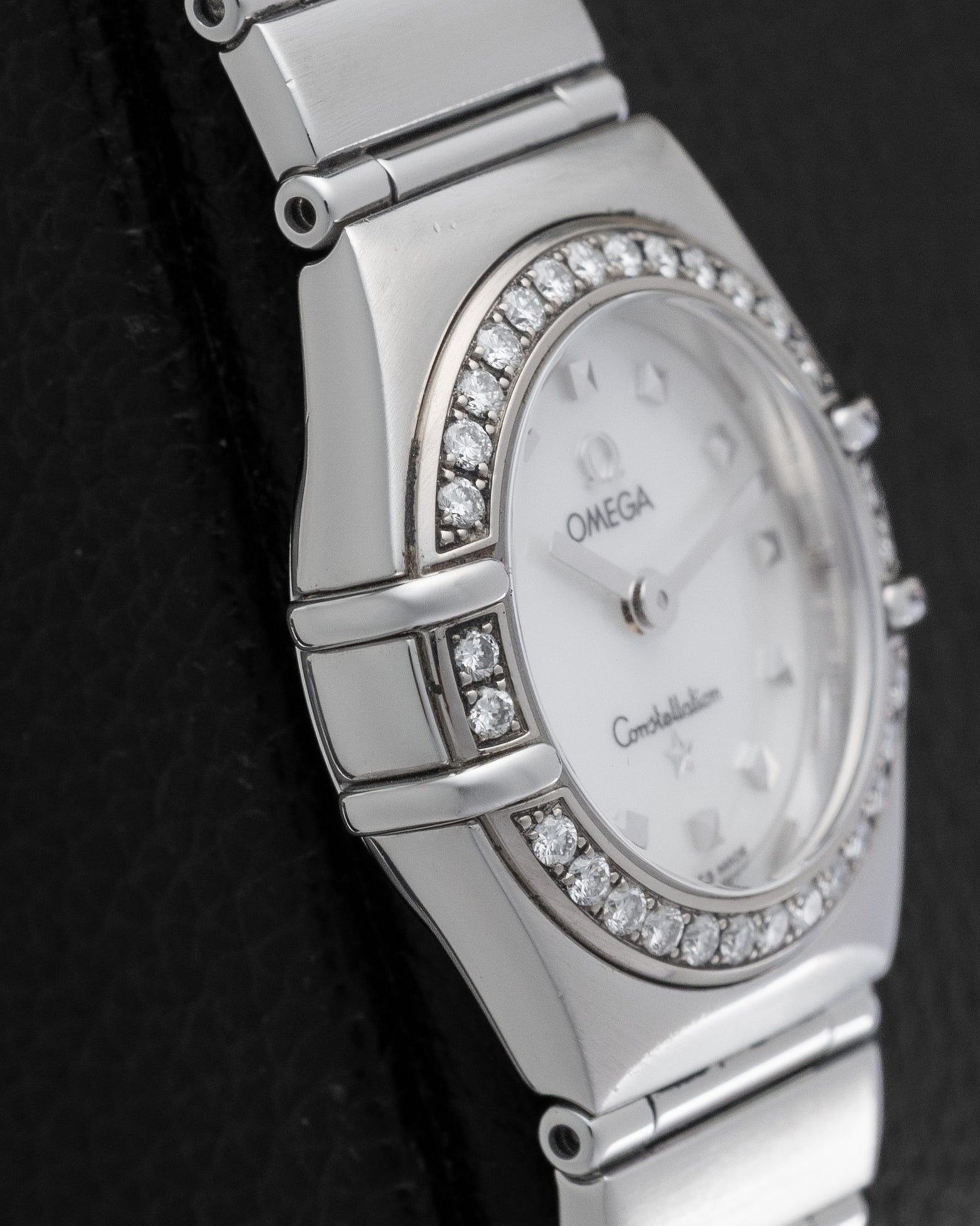Left side profile view highlighting the signature bezel claws and thin stainless steel case design of the Omega Constellation 1465.71.00.