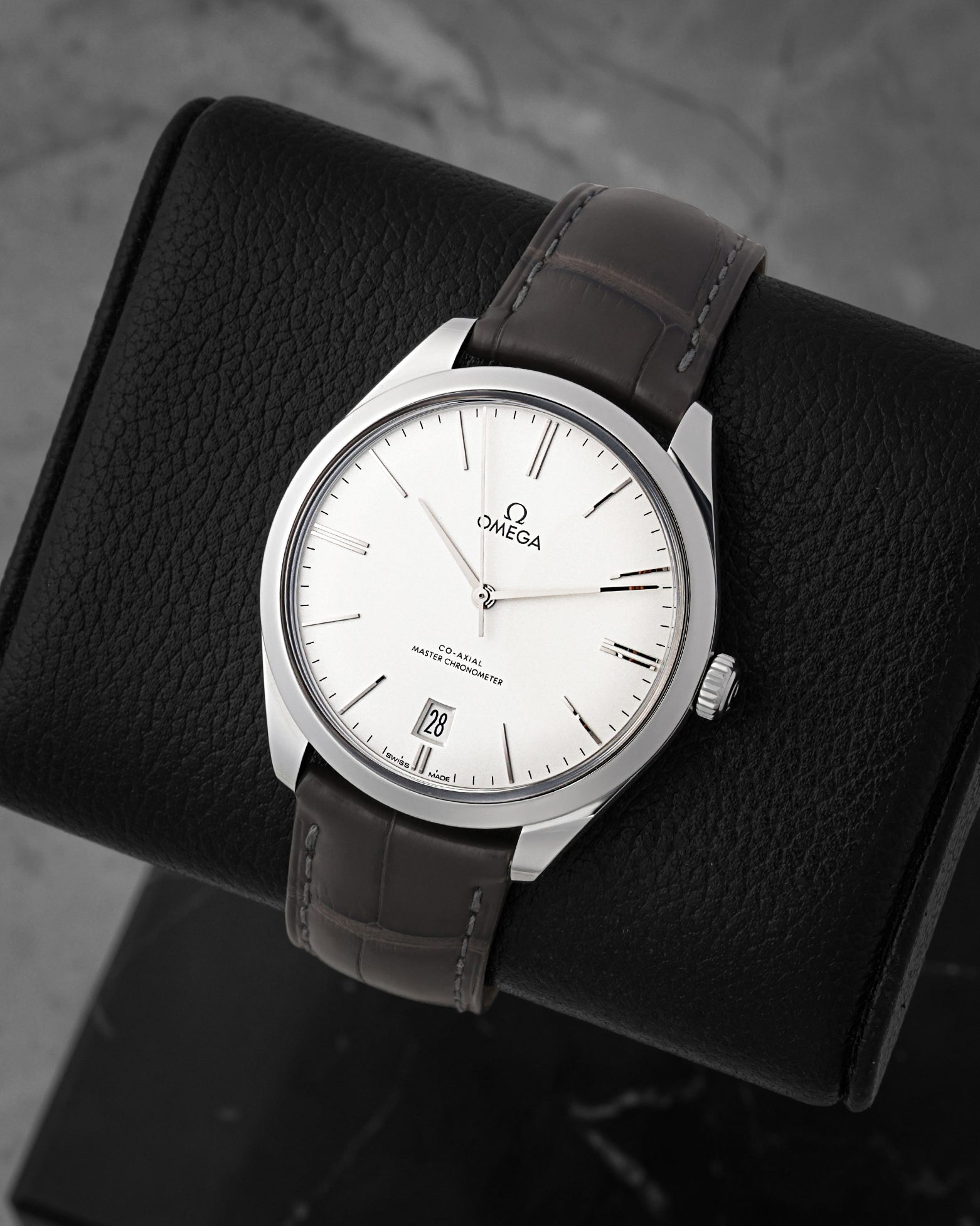 angled view of Omega De Ville Trésor with domed silver opaline dial and white gold hour markers