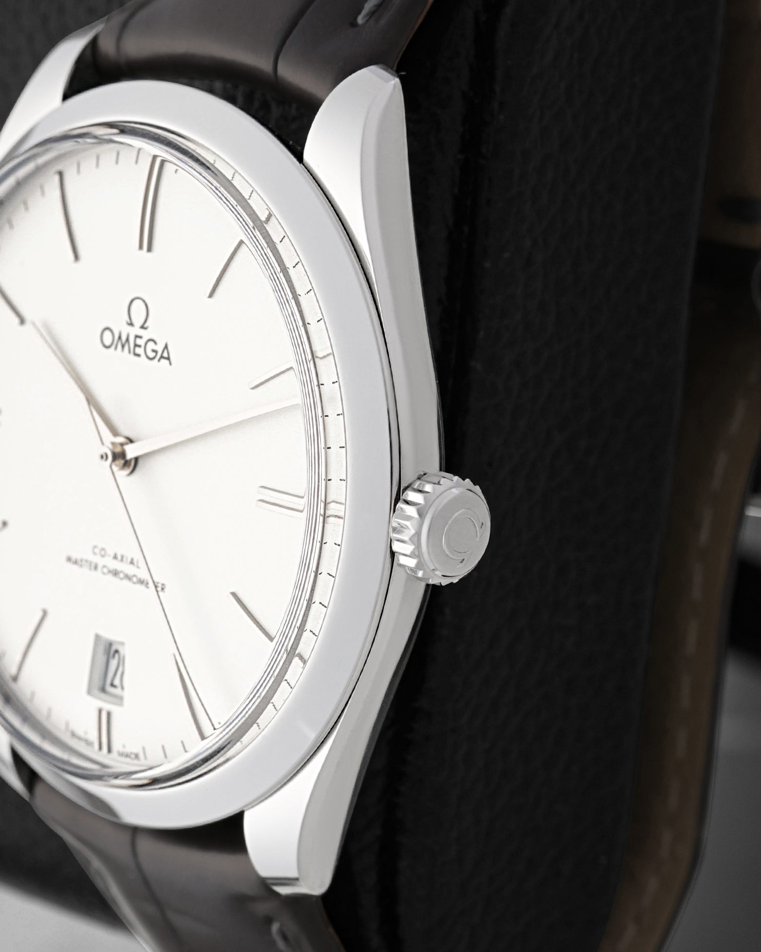 Close-up view of the polished crown on an Omega De Ville Trésor stainless steel case