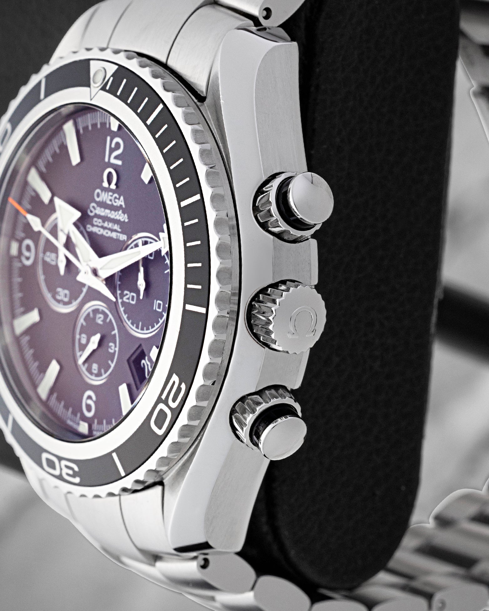Side profile of 45.5mm stainless steel case showing Omega crown and chronograph pushers on Planet Ocean 2210.50.00