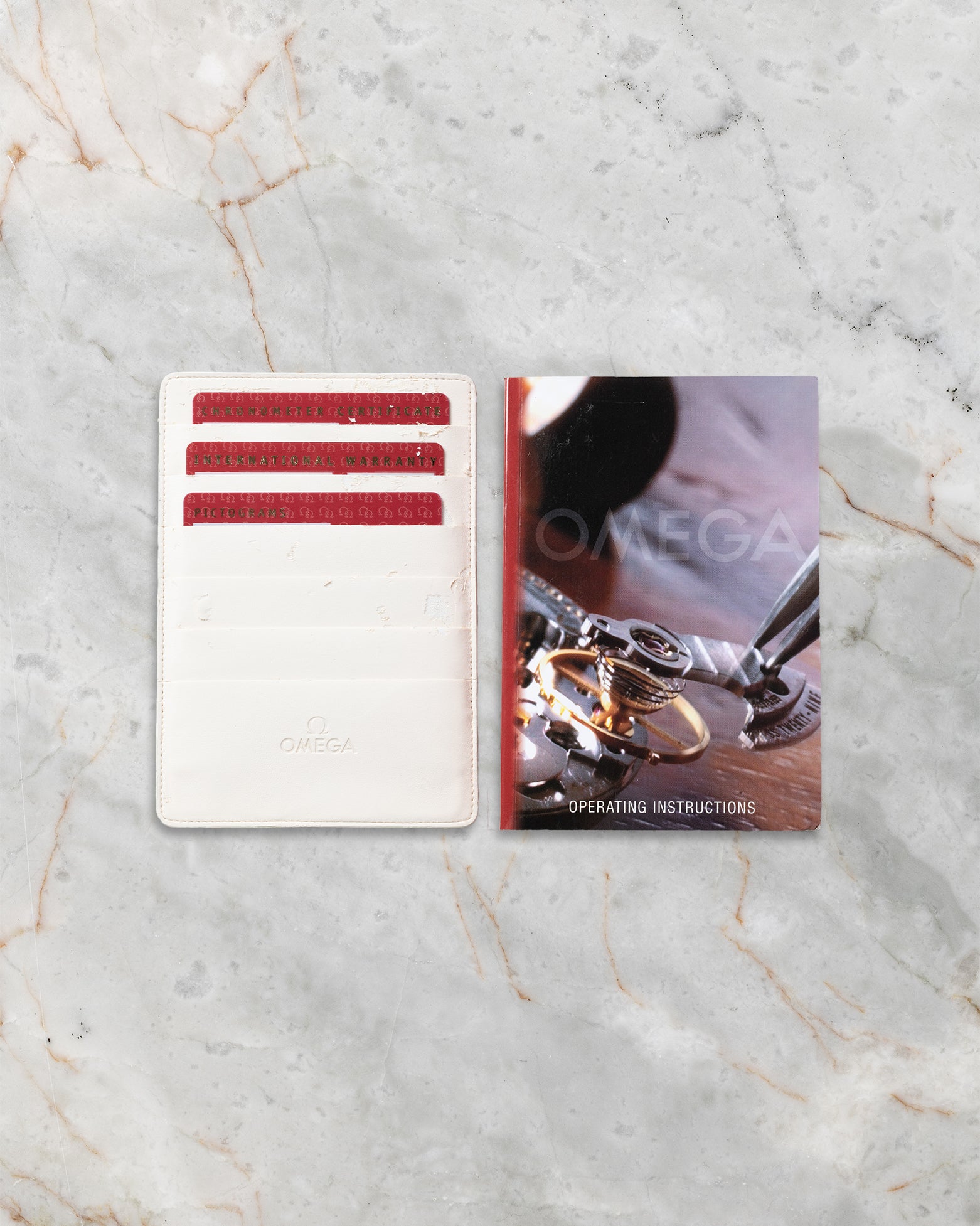 Official Omega pictogram cards, leatherette wallet, and operating manual for Planet Ocean Chronograph 2210.50.00