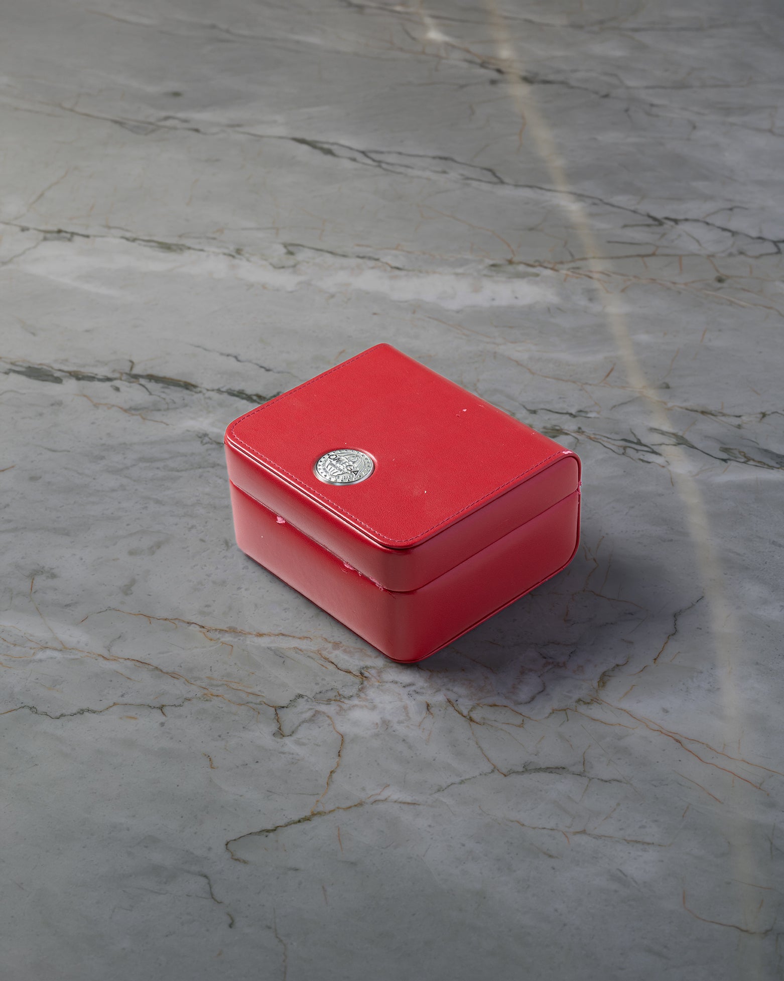 Iconic red Omega luxury watch presentation box included with pre-owned Planet Ocean 600M chronograph purchase