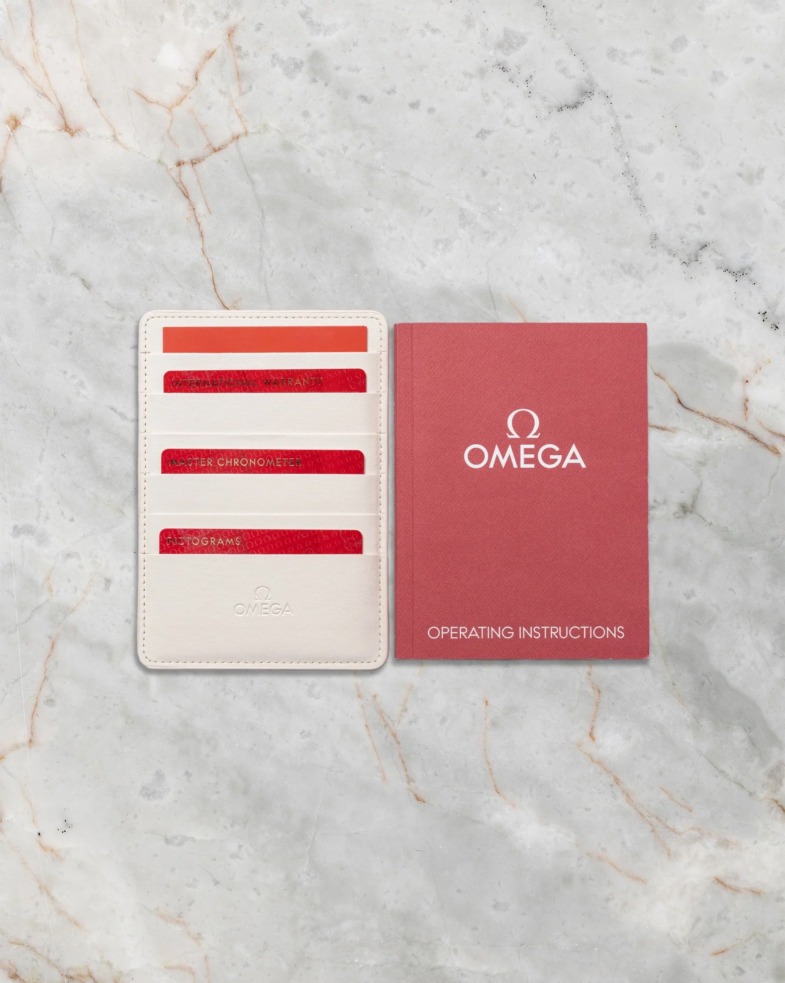 Official Omega international warranty cards, Master Chronometer certificate, wallet, and operating instruction manual