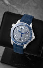 Angled view of 42mm Omega Seamaster Diver 210.32.42.20.06.001 showing chrome laser-engraved wave dial and blue ceramic bezel