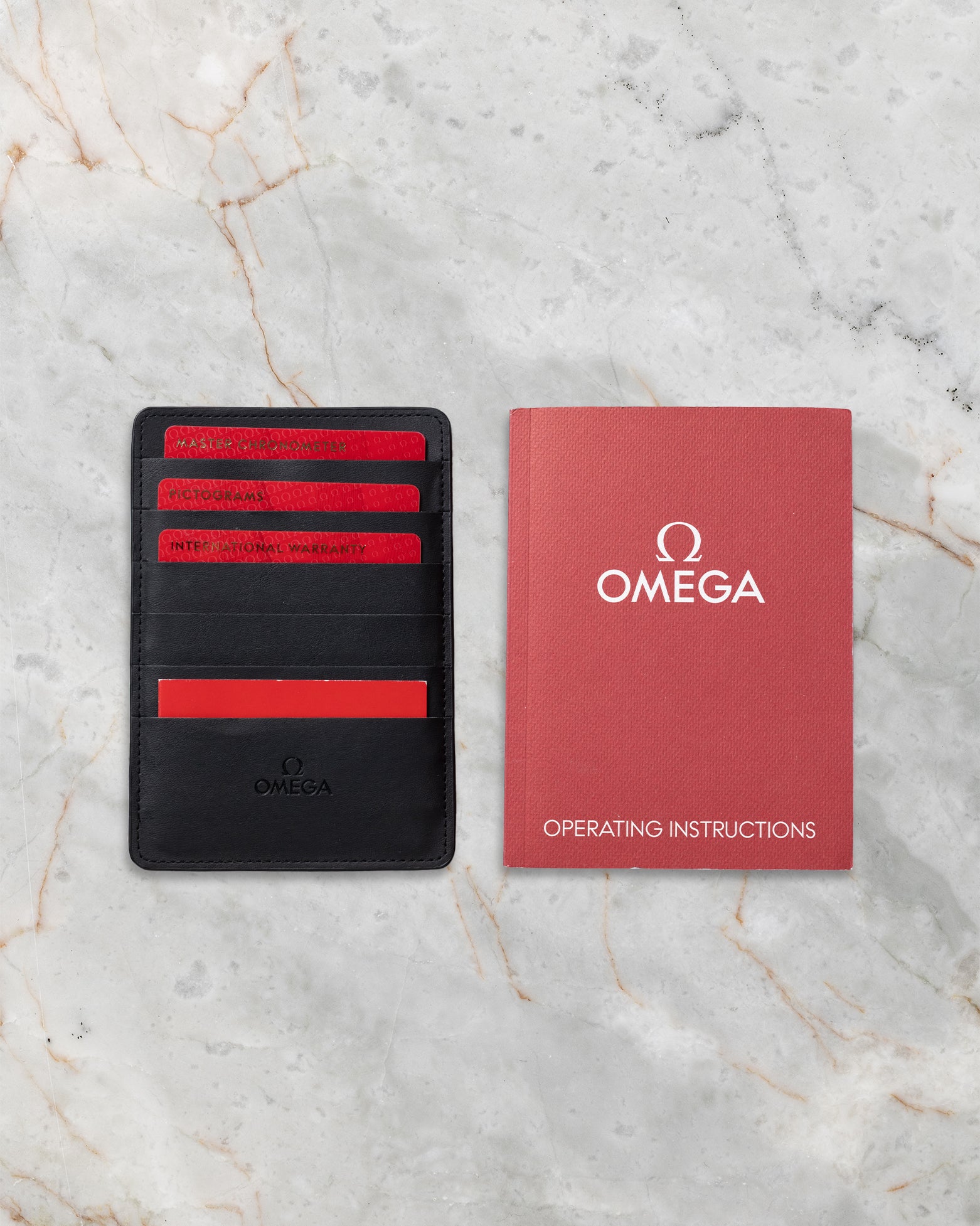 Official Omega Master Chronometer certificate cards, cardholder, and manual for Seamaster reference 210.60.42.20.99.001