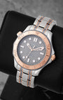 Angled view of Omega Seamaster 210.60.42.20.99.001 showing grey laser-engraved wave dial and 18k Sedna gold bezel