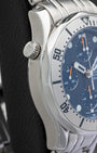Side profile view of the non-crown side of an Omega Seamaster Chronograph highlighting the signature helium escape valve