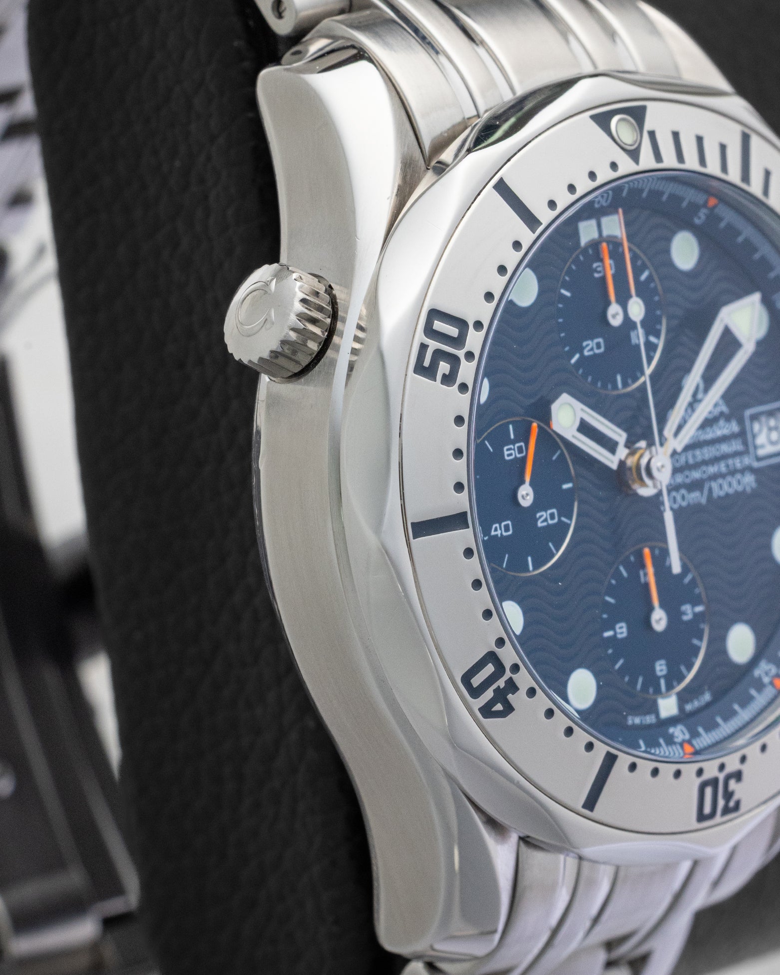 Side profile view of the non-crown side of an Omega Seamaster Chronograph highlighting the signature helium escape valve