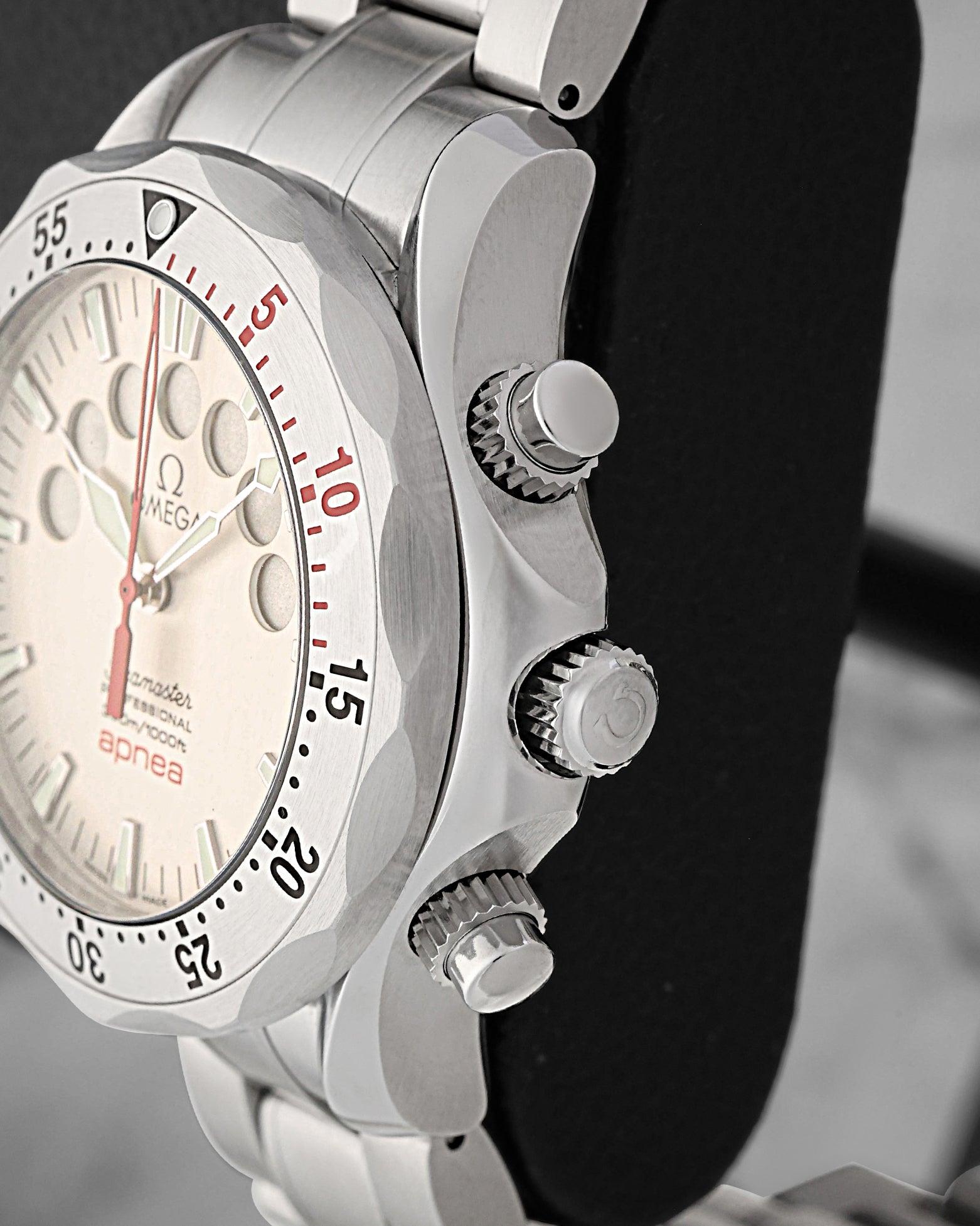 Close-up right profile view of the watch head highlighting the heavy-duty fluted screw-down crown flanked by two oversized knurled chronograph pushers engineered for marine operations