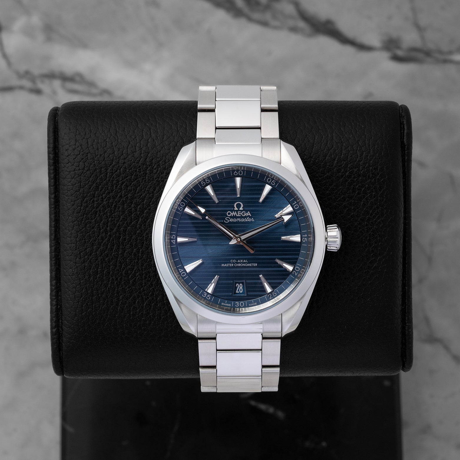 2022 pre-owned Omega Seamaster Aqua Terra 150M reference 220.10.41.21.03.004 featuring a blue horizontal teak-pattern dial and stainless steel bracelet, displayed on a watch cushion.