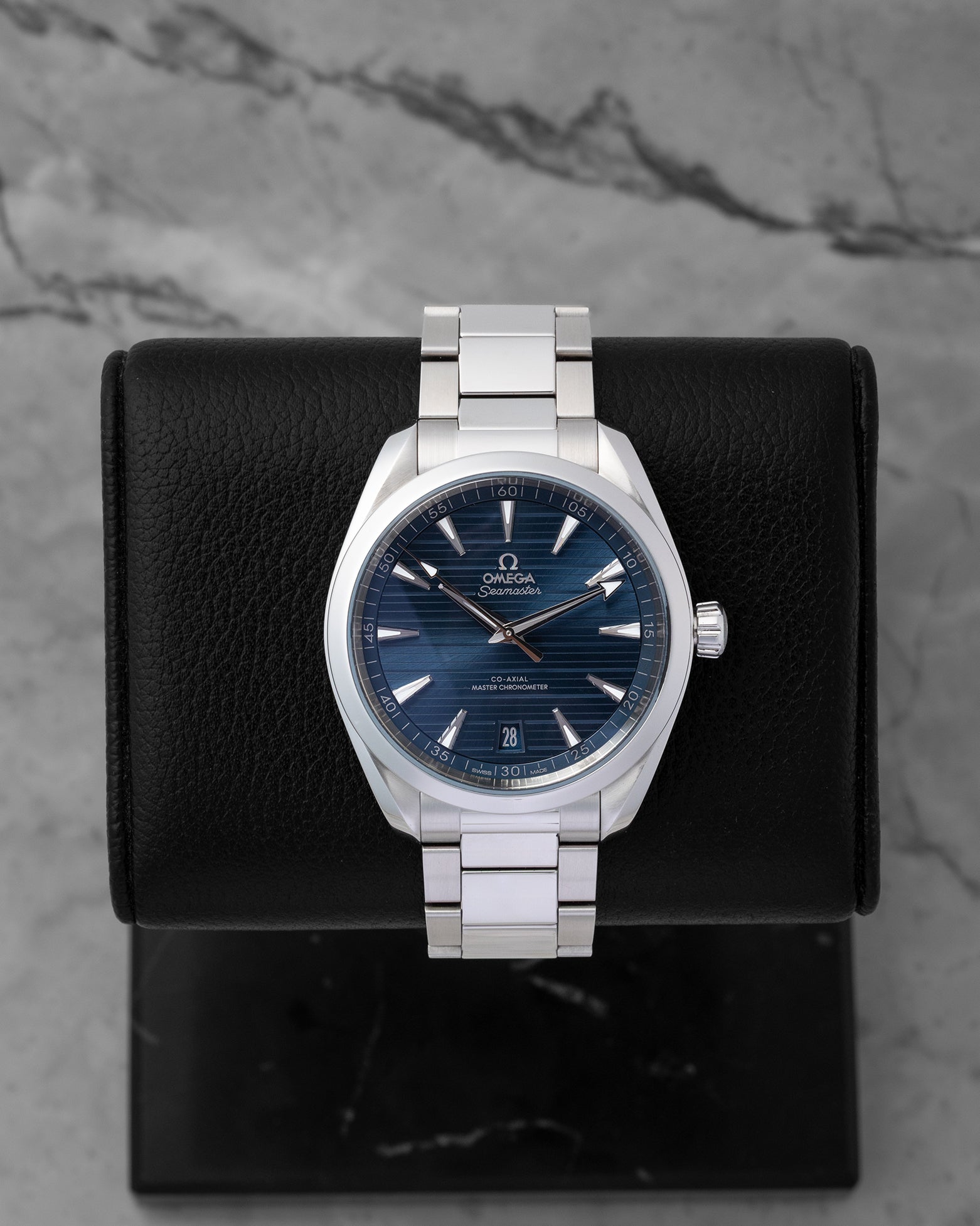 2022 pre-owned Omega Seamaster Aqua Terra 150M reference 220.10.41.21.03.004 featuring a blue horizontal teak-pattern dial and stainless steel bracelet, displayed on a watch cushion.