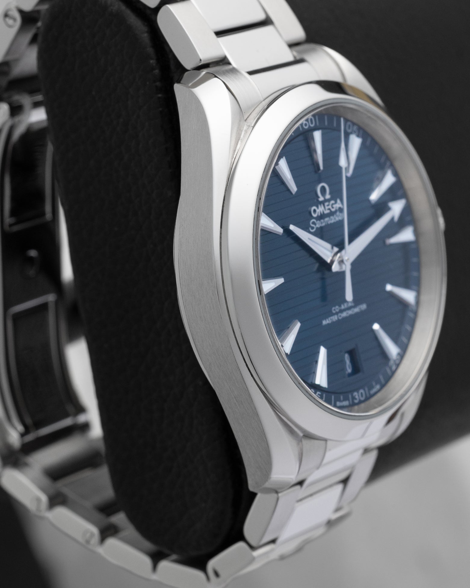 Left side profile view highlighting the twisted lyre lugs and polished stainless steel case edge of the Omega Aqua Terra 220.10.41.21.03.004.