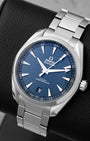 Angled shot of a pre-owned 2022 Omega Seamaster Aqua Terra 41mm showing the blue teak dial, date window at 6 o'clock, and brushed stainless steel bracelet.