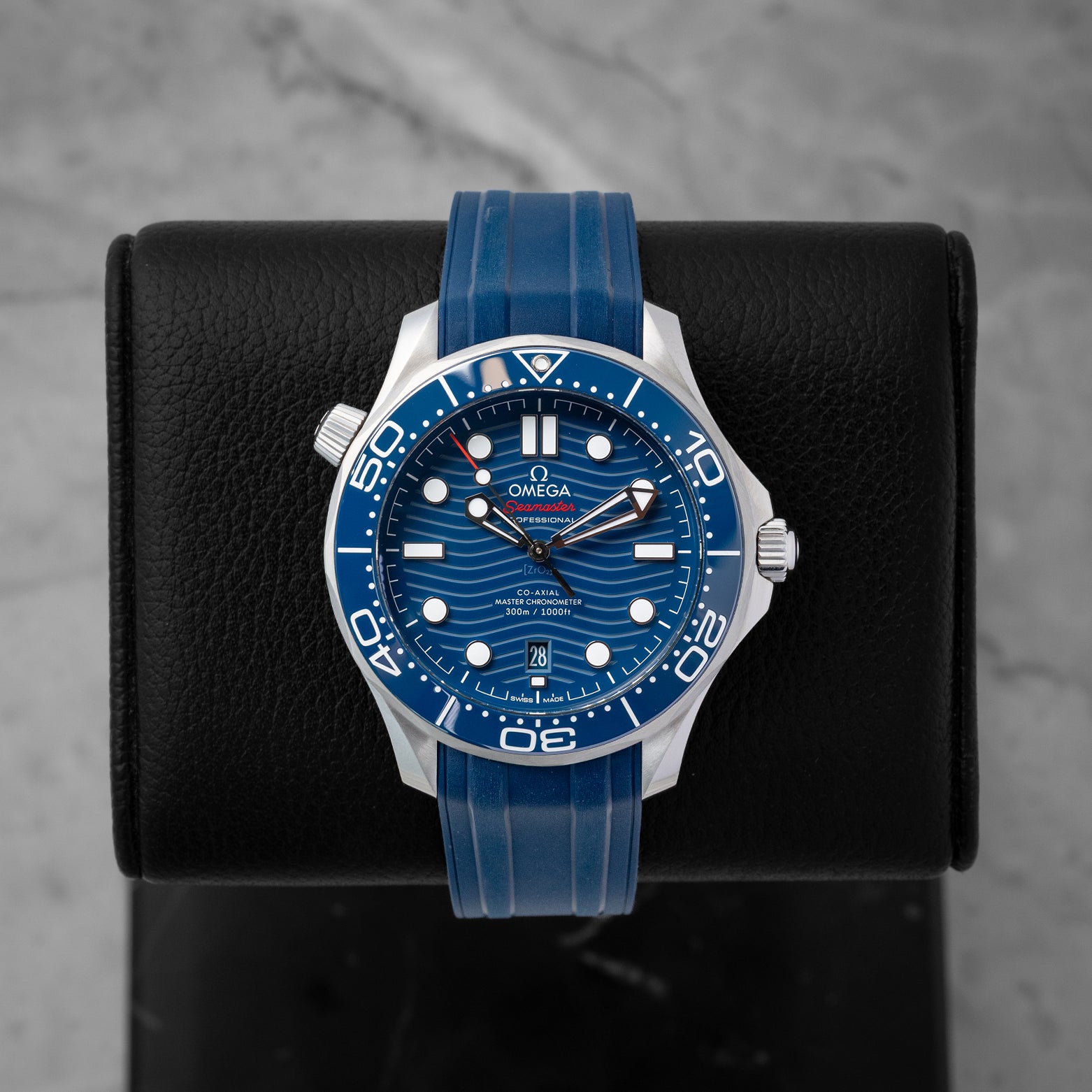 2024 Omega Seamaster Diver 300M reference 210.32.42.20.03.001 featuring a blue ceramic laser-engraved wave dial, ceramic bezel, and blue rubber strap.