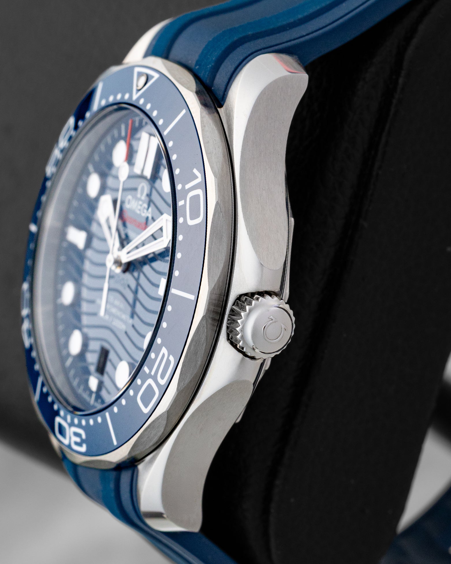 Right side view of the 2024 Omega Seamaster Diver 300M stainless steel case, crown guards, and blue ceramic bezel ring.