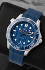 Angled perspective of a 2022 Omega Seamaster Diver 300M Co-Axial Master Chronometer 42mm watch on a matching blue rubber strap.
