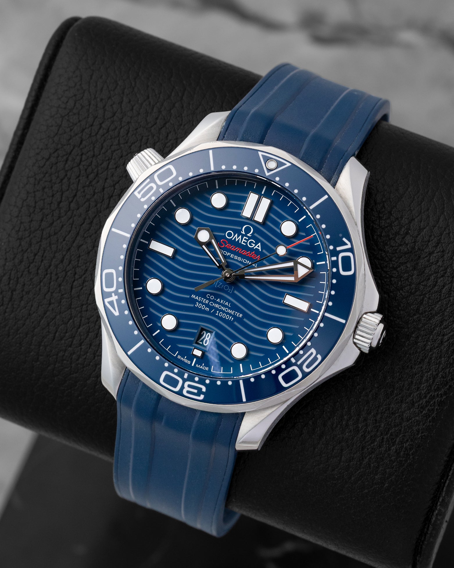 Angled perspective of a 2022 Omega Seamaster Diver 300M Co-Axial Master Chronometer 42mm watch on a matching blue rubber strap.