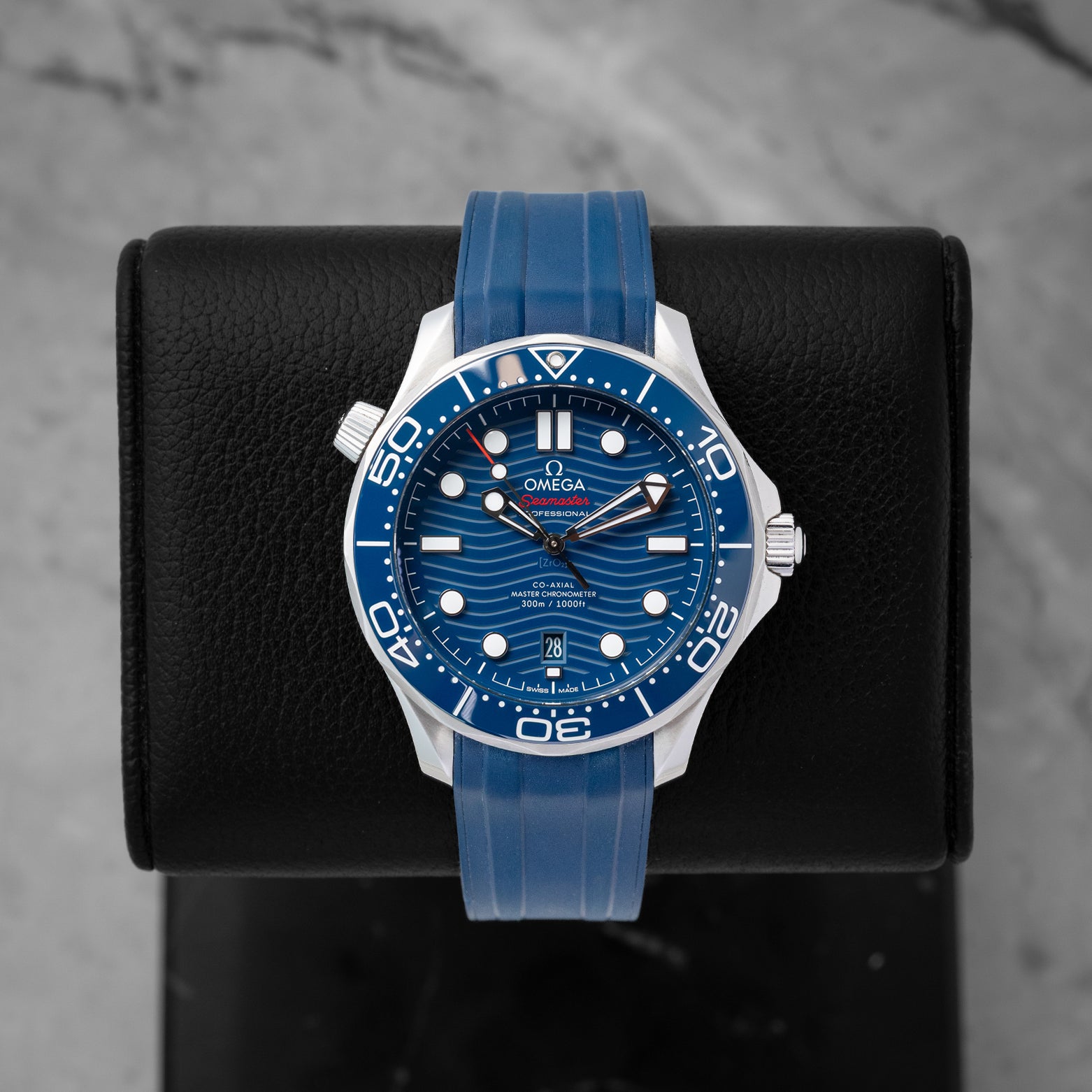 2022 Omega Seamaster Diver 300M reference 210.32.42.20.03.001 featuring a blue ceramic laser-engraved wave dial, ceramic bezel, and blue rubber strap.