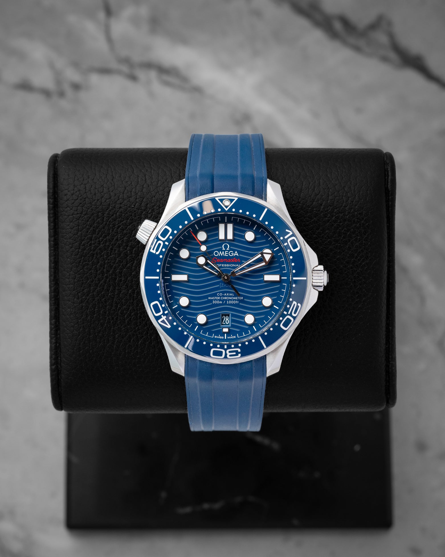 2022 Omega Seamaster Diver 300M reference 210.32.42.20.03.001 featuring a blue ceramic laser-engraved wave dial, ceramic bezel, and blue rubber strap.