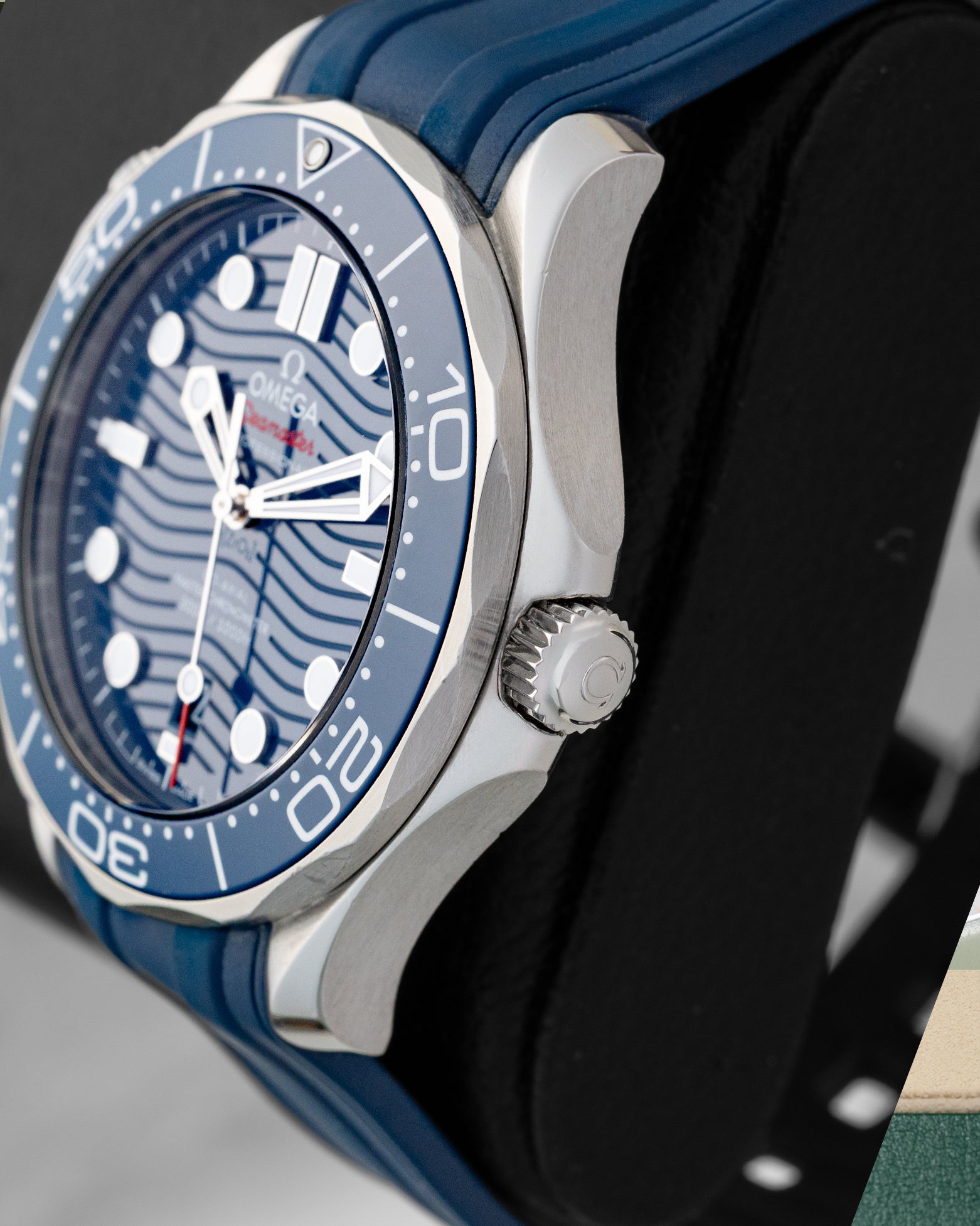 Right side view of the 2022 Omega Seamaster Diver 300M stainless steel case, crown guards, and blue ceramic bezel ring.