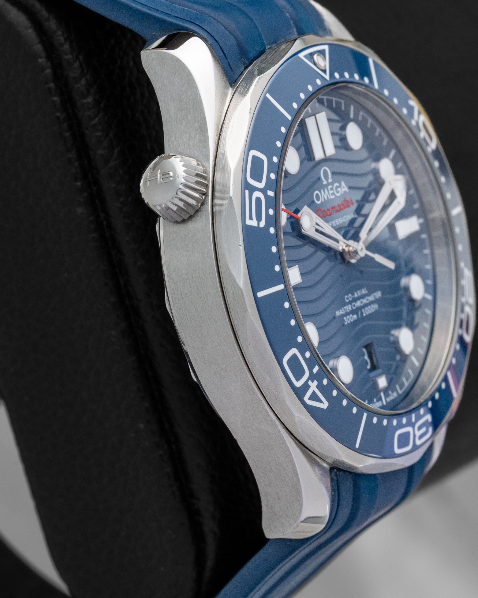 Left side profile view highlighting the conical helium escape valve at 10 o'clock on the 2022 Omega Seamaster Diver 300M.