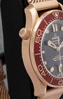 Side profile showing the 42mm Bronze Gold case and mesh bracelet on an Omega Seamaster Diver 300M