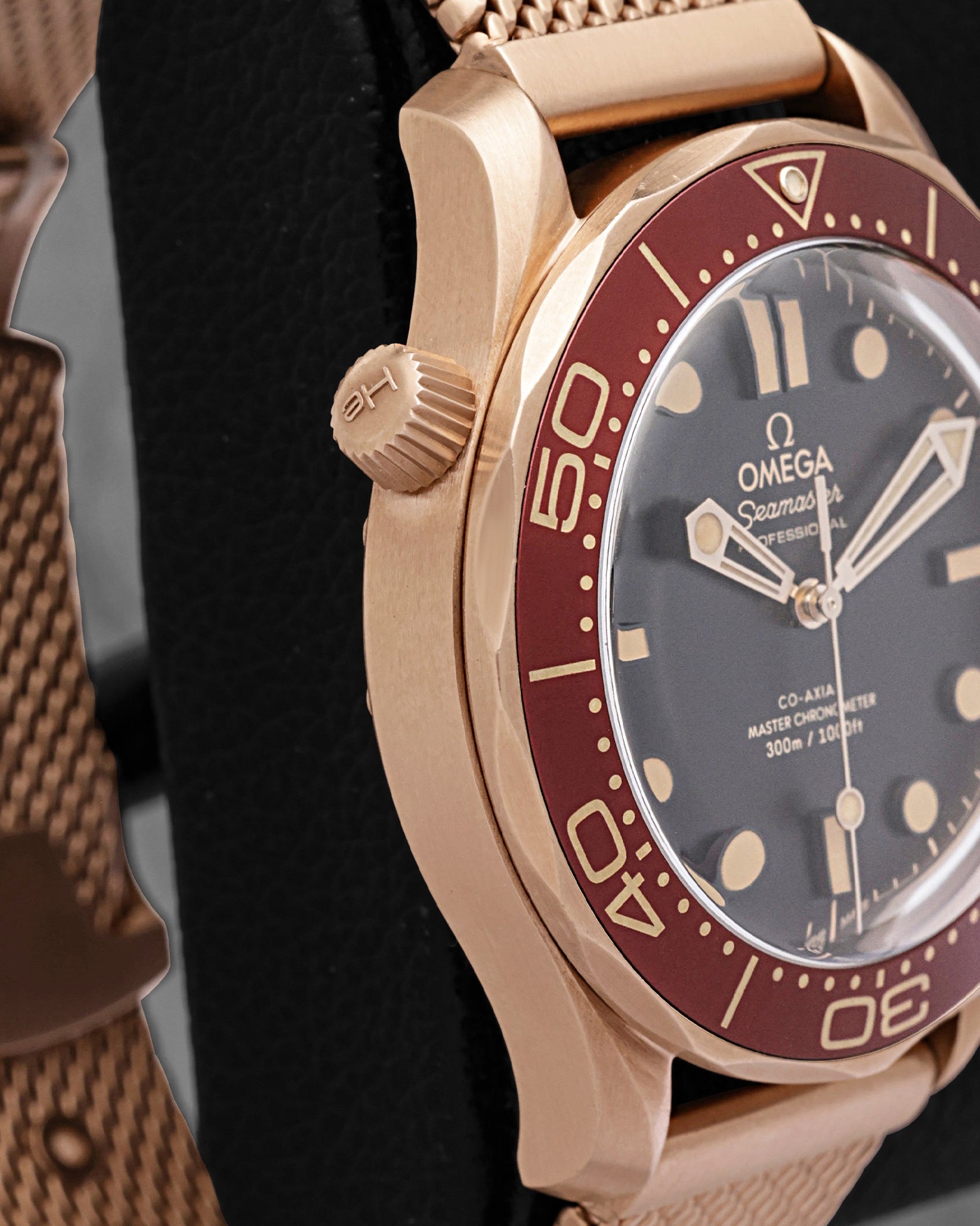 Side profile showing the 42mm Bronze Gold case and mesh bracelet on an Omega Seamaster Diver 300M