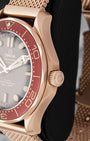 Close-up view of the screw-in crown and burgundy bezel on an Omega Seamaster Diver 300M