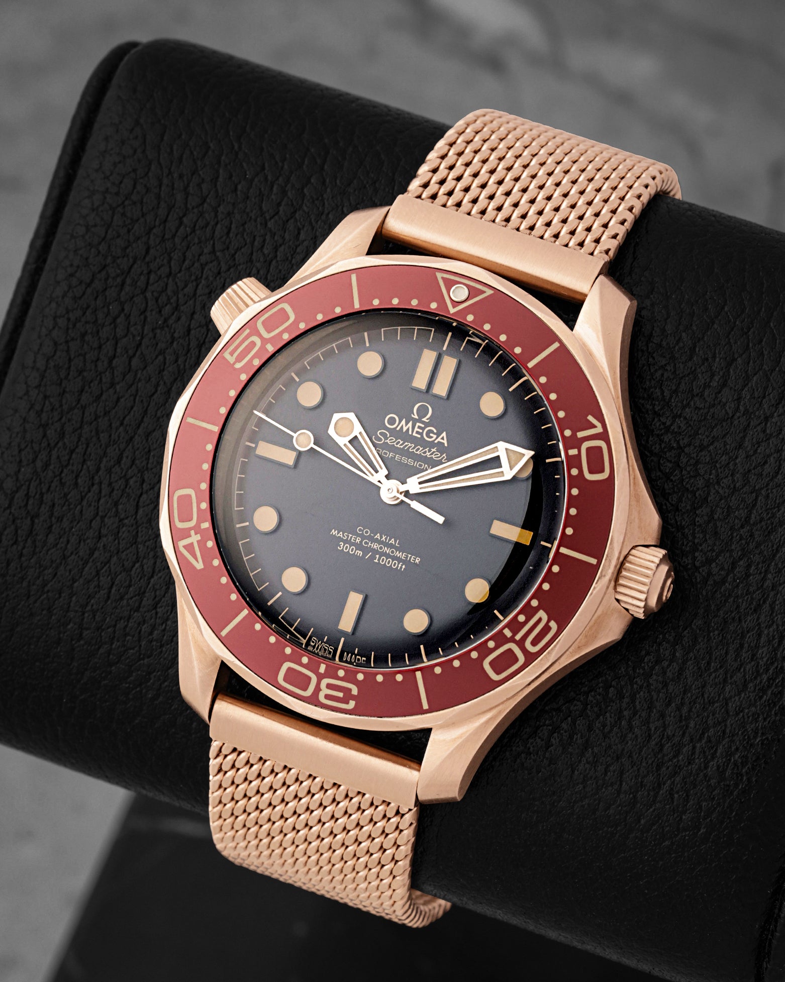 Angled view of Omega Seamaster Diver 300M 42mm Bronze Gold watch with burgundy bezel