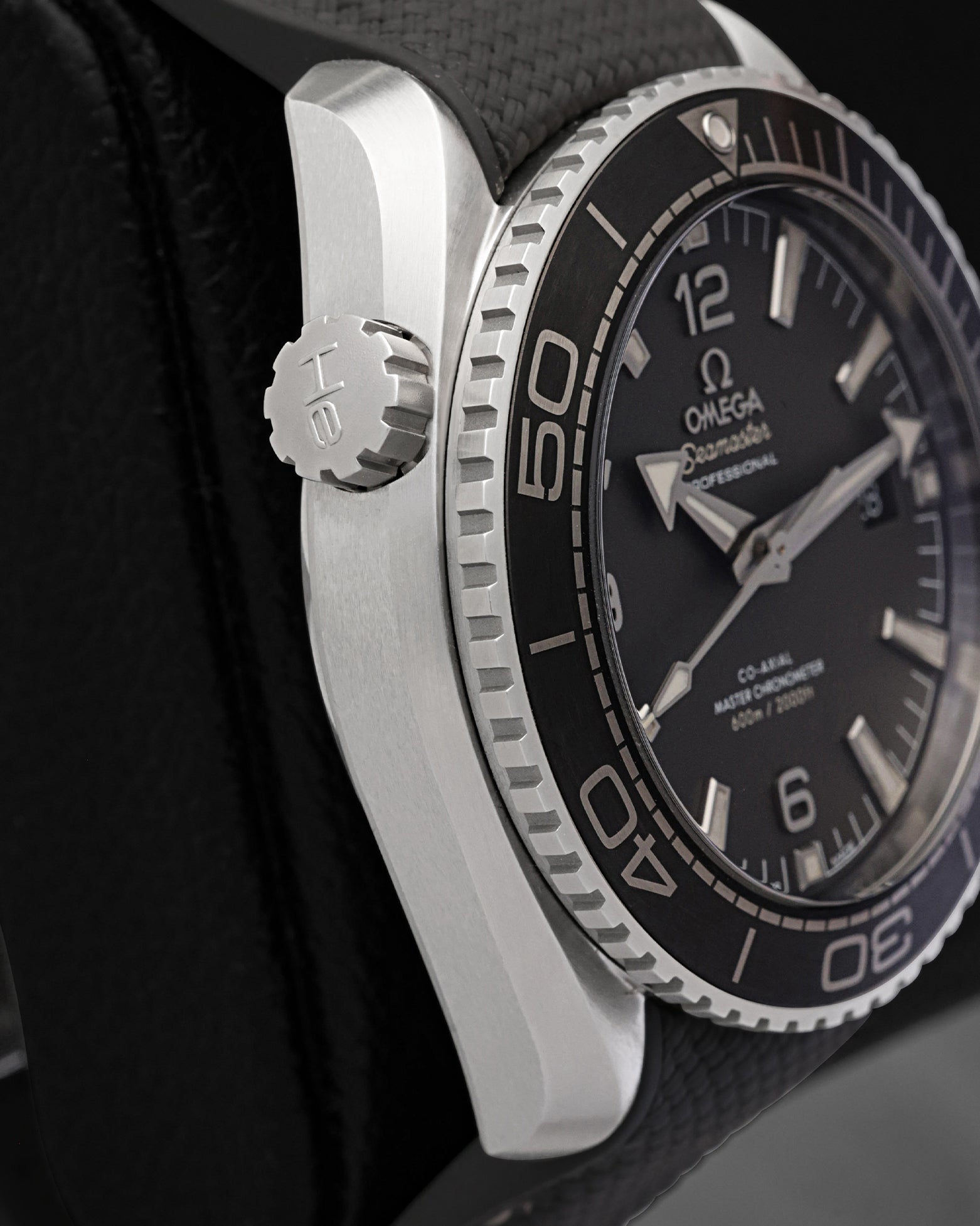 Side view of the 11 o'clock helium escape valve on an Omega Seamaster Planet Ocean 600M steel case