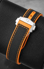 Black structured rubber strap with orange stitching and stainless steel double push-button deployant clasp