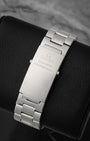 A rear view of the satin-finished three-link stainless steel bracelet focusing on the classic fold-over professional deployment clasp engraved with the Omega Seamaster speedmaster emblem text