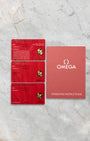 Original red Omega international warranty card set, pictograms, Master Chronometer card, and manual included with Speedmaster 310.30.42.50.01.002