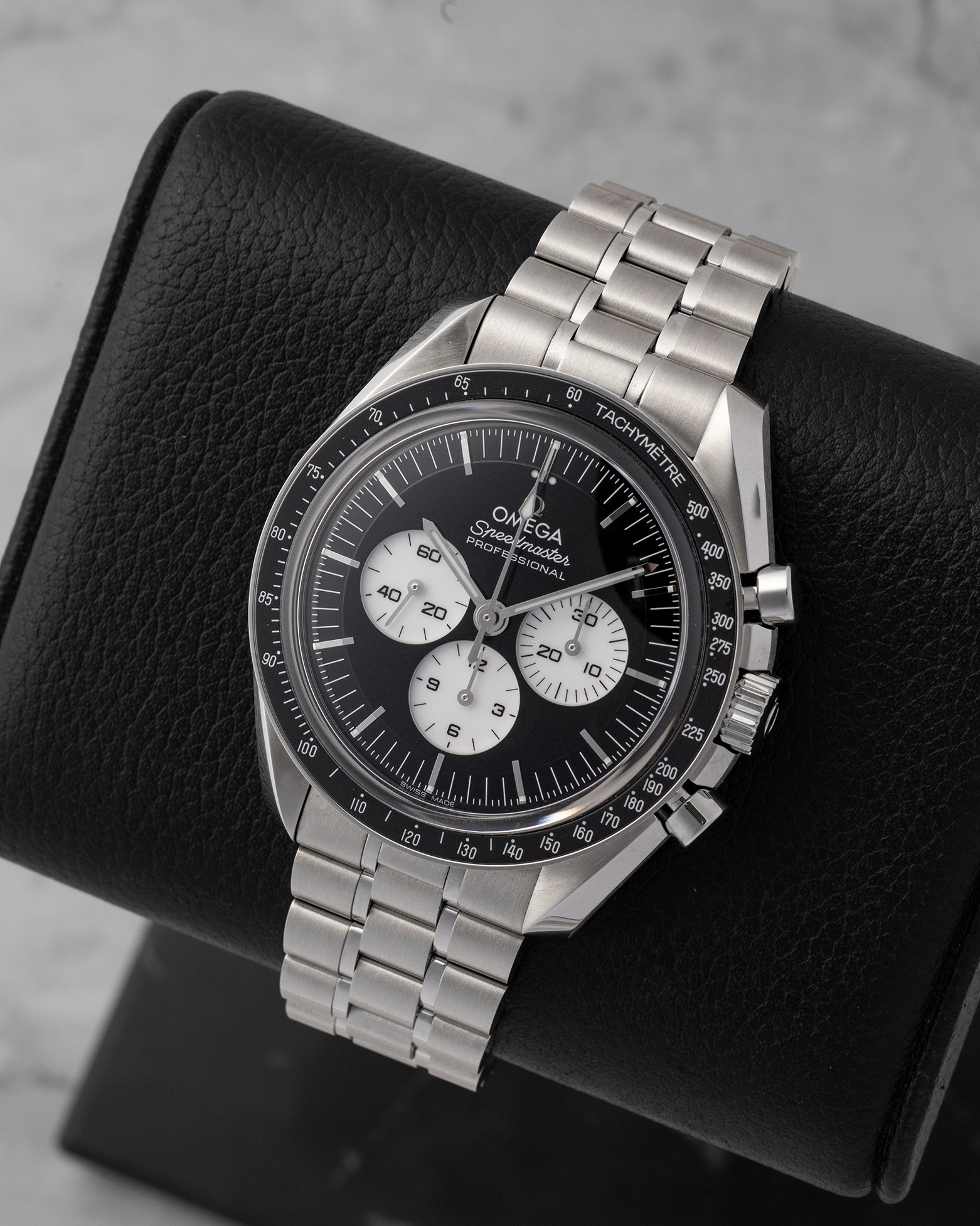 Angled view of preowned Omega Speedmaster Moonwatch Professional 310.30.42.50.01.004 featuring a black step dial with white sub-dials