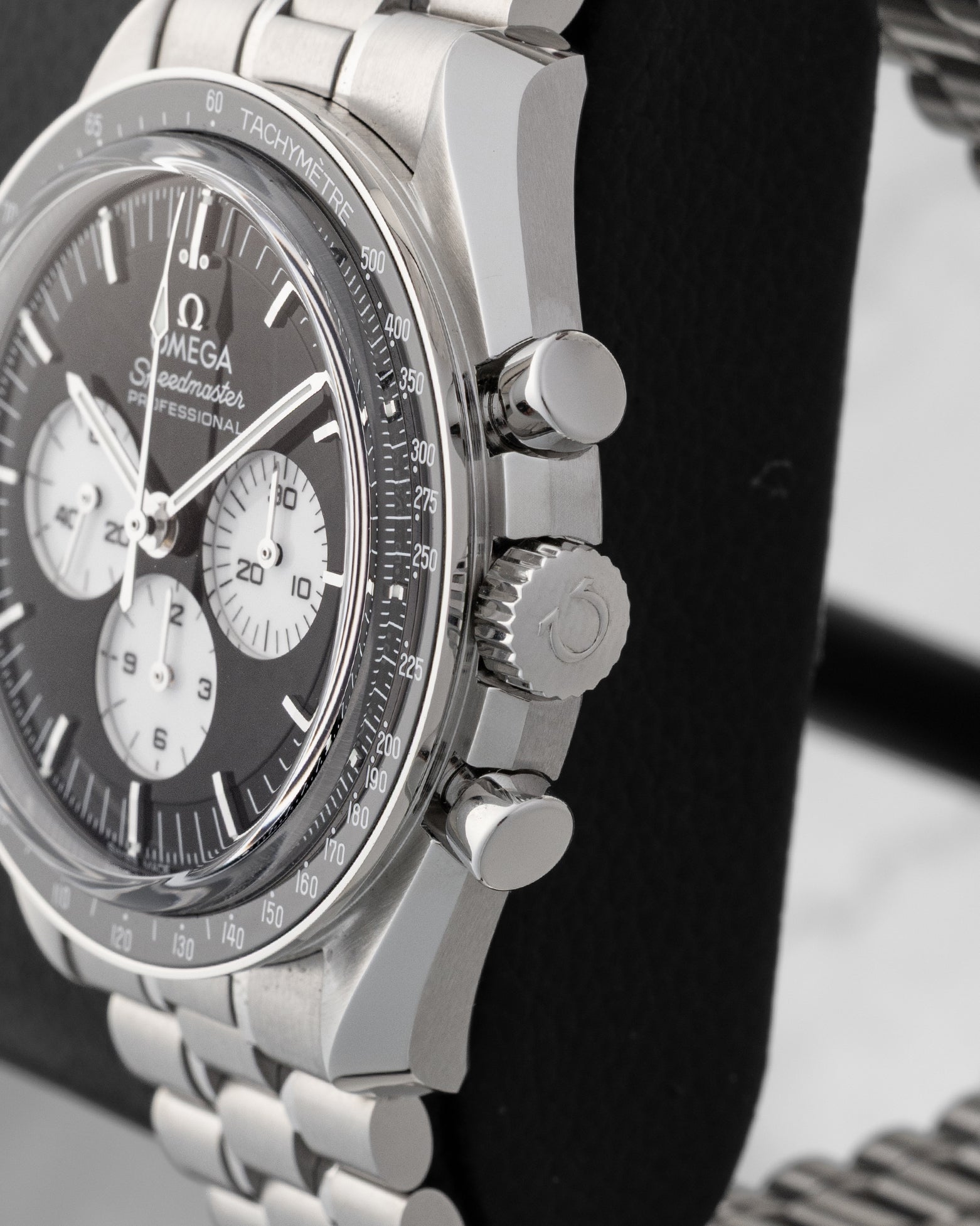 Side profile view displaying the stainless steel case, winding crown, and chronograph pushers on Omega Speedmaster Reverse Panda 310.30.42.50.01.004