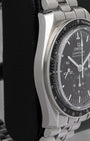 Left-side macro profile view capturing the distinctive satin-brushed caseband flank and the iconic twisted lyre sports lugs flowing into a tapered steel link band