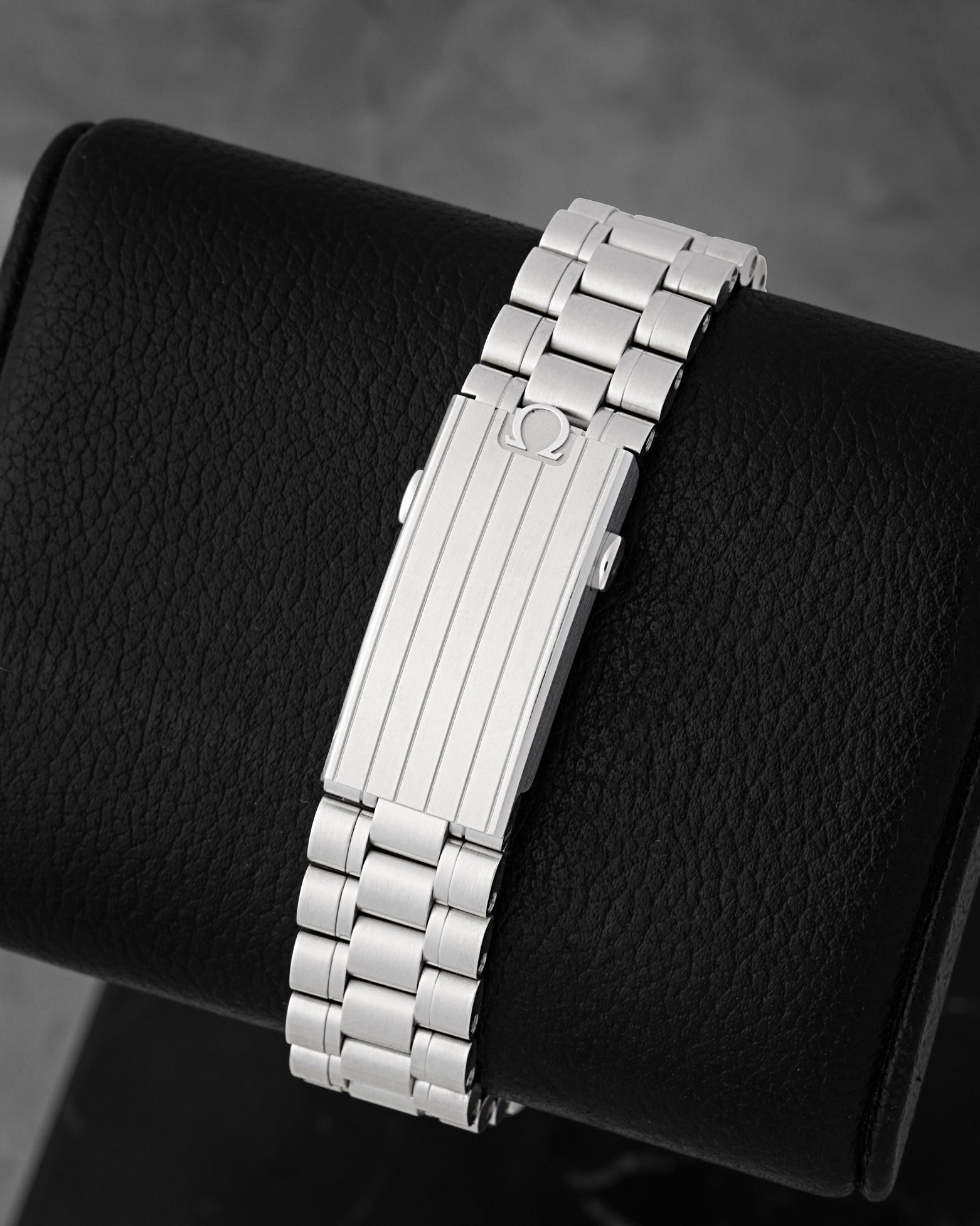 Fully brushed five-link stainless steel bracelet and micro-adjust clasp on an Omega Speedmaster Hesalite
