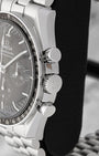 Close-up of the winding crown and tactile chronograph pushers on an Omega Speedmaster Hesalite